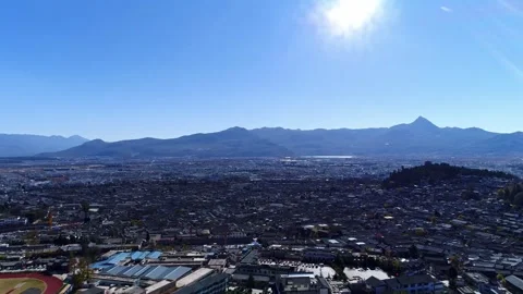 Aerial view of ancient city connected residential houses distant mountain city Video stock 337923593