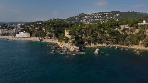 Aerial view of ancient cliff-top fortress above emerald sea Stock Footage 321345906