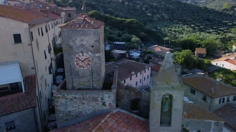 Aerial view of an ancient clock tower in Castiglione della Pescaia Stock Footage 253127749