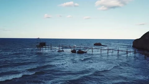 Aerial view - Ancient fishing machine built on the sea rock called Trabocco Stock Footage 215633554