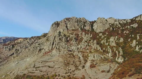 Aerial view of ancient rocks of bizarre shape in places overgrown with scanty pl Stock Footage 151153505