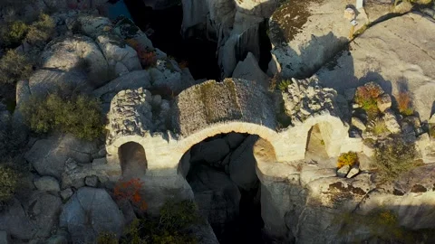 Aerial view of ancient stone bridge ruins at golden hour Stock Footage 317384400