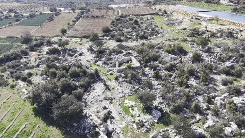 Aerial View of Ancient Stone Ruins Near Agricultural Fields - 4K Stock Footage 331805243