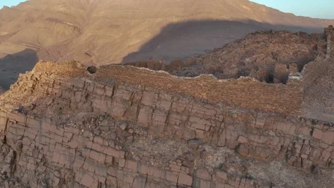 Aerial View of Ancient Stone Ruins on Desert Mountain Ridge Stock Footage 336025307