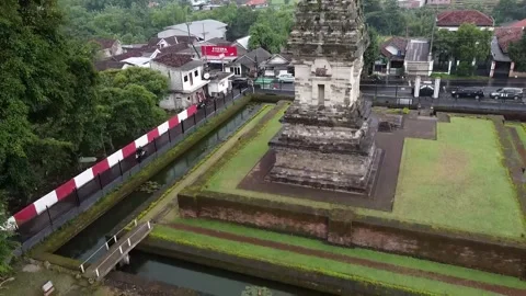 Aerial view of ancient stone temple with moat in urban area - Jawi Temple Video stock 279541516