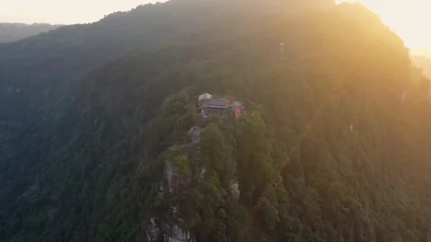 Aerial View of Ancient Temple Perched on Mountain Peak During Golden Hour Sunset Video stock 342027314