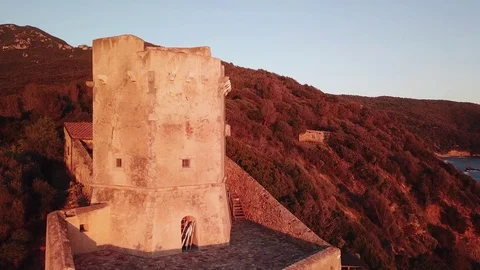 Aerial view of an ancient tower on the cliff at Sunset  Stock Footage 106540775