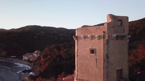 Aerial view of an ancient tower on the cliff at Sunset Stock Footage 106541241