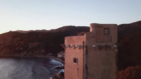 Aerial view of an ancient tower on the cliff at Sunset  Stock Footage 106541434