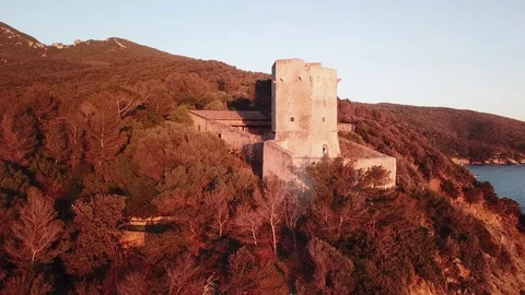 Aerial view of an ancient tower on the cliff at Sunset  Stock Footage 106541840