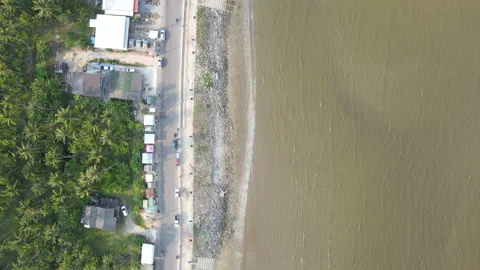 Aerial view and look down area of coast and beach with road along the way Video stock 153394552