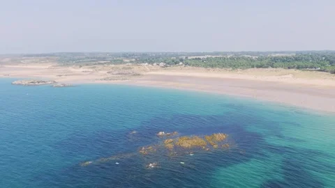 Aerial view of Anse du Croc beach in Frehel, Brittany, France, showing turquoise Stock Footage 346665517