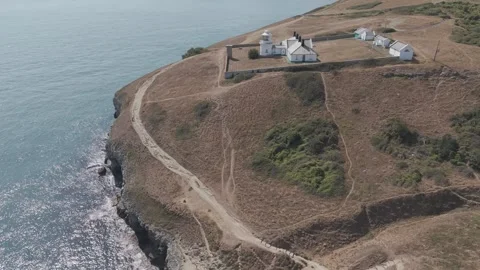 Aerial View of Anvil Point Lighthouse on Rocky Cliffs in Swanage Dorset UK Stock Footage 342769408