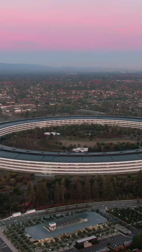 Aerial view of Apple Park at dusk, surrounded by trees. , Cupertino, USA Stock Footage 317601245