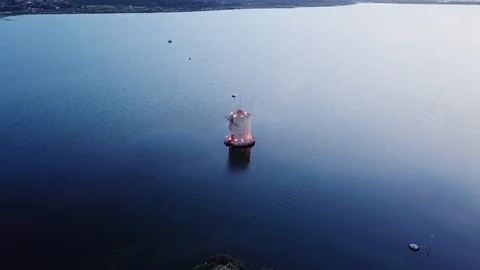 Aerial View Approach to an ancient romantic windmill on a sea lagoon at sunset Stock Footage 107848072