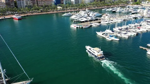 Aerial view with approach yo beauiful yacht entering in Marina Alicante. Stock Footage 140870082