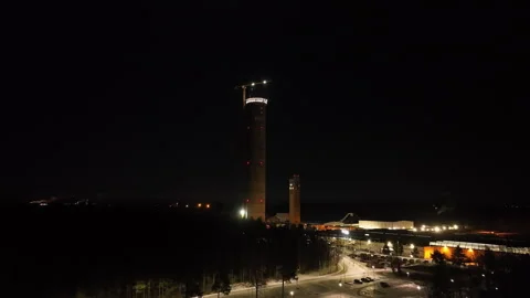 Aerial view approaching the highest structure in industry, winter night in Stock Footage 312866386