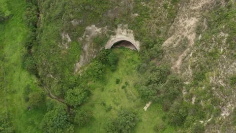 Aerial view approaching a large cave with a typical entrance Stock Footage 142747041