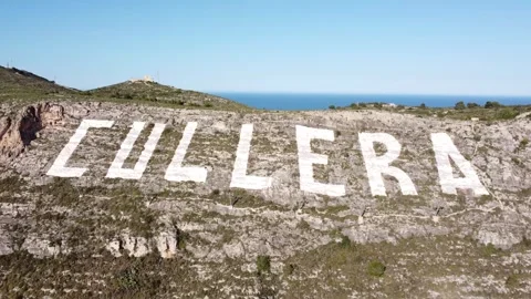 Aerial view approaching the large sign painted of Cullera, Valencia Stock Footage 268574584