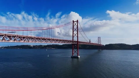 Aerial view of April 25th bridge crossing Tagus river on a bright cloudy day Stock Footage 255115976