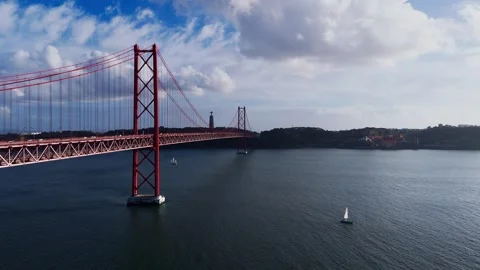 Aerial view of April 25th bridge crossing Tagus river on a bright cloudy day Stock Footage 255116029
