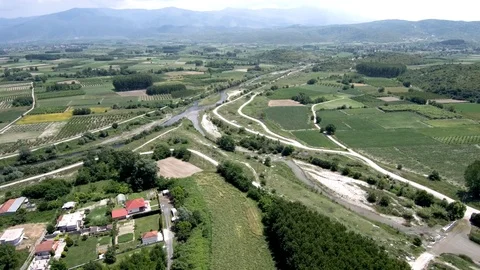 Aerial view of arable land with small river and village in Aridaia Greece Stock-Footage 115047976