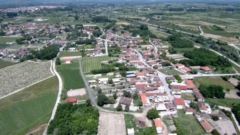 Aerial view of arable land with small village in Aridaia Greece Stock Footage 115057154