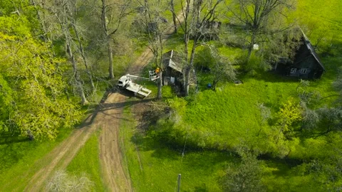 Aerial View of an Arborist Cutting Trees with a Bucket Truck Видео 336688179