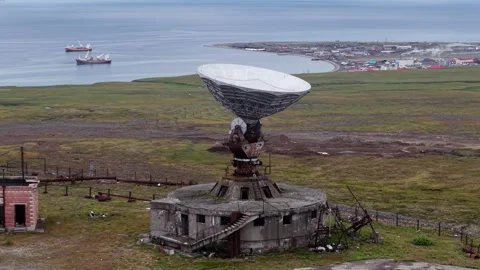 Aerial view of Arctic coastline with Orbita radar and cargo road toward Lavrenti Stock Footage 327121496