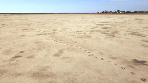 Aerial view of arid drought affected dried up desert lake remote Stock Footage 134599296