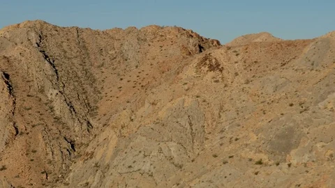 Aerial view of arid Mountain Range Mojave desert remote Extreme Terrain Stock Footage 76850380