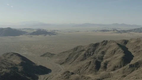 Aerial view of arid Mountain Range Mojave desert a remote Extreme Terrain Stock Footage 76853477