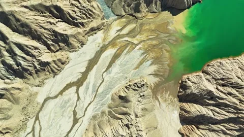 Aerial View of Arid Mountains and Green Lake Convergence in Western China Stock Footage 346332494