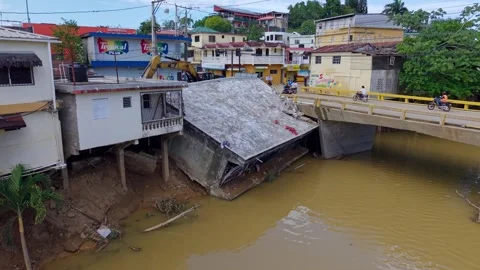 Aerial view around a collapsed building in river at sunny Crecida de Rio village Stock Footage 334636109