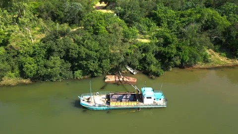 Aerial view around a sand mining boat, on the Rio Parana river, in sunny Stock Footage 263724940