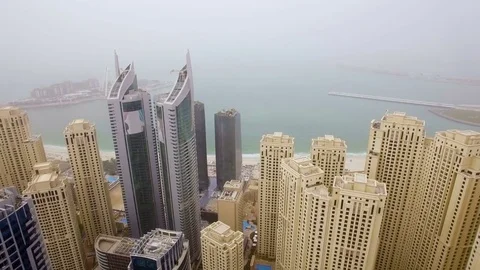 Aerial view of the array of skyscrapers facing the sea in the small fog. Dubai Stock Footage 72934777
