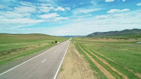 Aerial view of an asphalt road through the rural countryside area, road between Stock-Footage 187078271