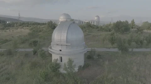 Aerial View of Astronomical Observatory Domes Amidst Green Hills Stock Footage 341978353