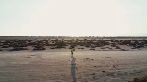 Aerial view of athlete doing cross country running in desert Stock Footage 132166972