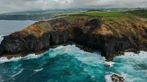 Aerial view of Atlantic waves breaking against volcanic cliffs on Azores Stock Footage 340069953