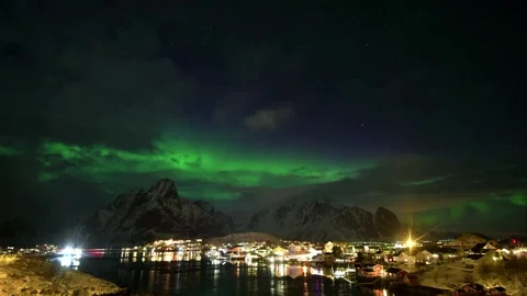 Aerial view of aurora borealis over a coastal village in Lofoten, Norway. Stock Footage 334832610