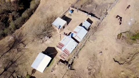 Aerial view of authentic mountain house and cliff, descending aerial shot Stock Footage 89801874