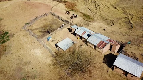 Aerial view of authentic mountain house and horses, DOLLY aerial shot Stock Footage 89860895