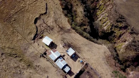 Aerial view of authentic mountain house and surroundings, Descending drone shot Stock Footage 89869566