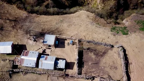 Aerial view of authentic mountain house and person walking, drone shot Stock Footage 89877991
