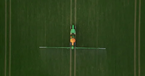 Aerial view of autonomous self-driving tractor with autopilot spraying mineral Stock Footage 271665264
