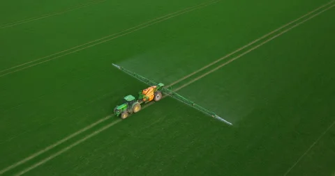 Aerial view of autonomous self-driving tractor with autopilot spraying mineral Stock Footage 272262649