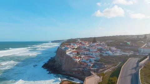 Aerial view of Azenhas do Mar at sunrise: Cliffside village and natural poo.. Stock Footage 240632730