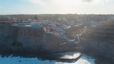 Aerial view of Azenhas do Mar at sunrise with the village on the cliff and .. Stock Footage 240632737