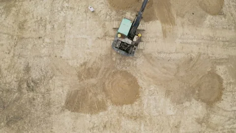 Aerial view of backhoe is digging grove in the agricultural garden area Stock Footage 156973228